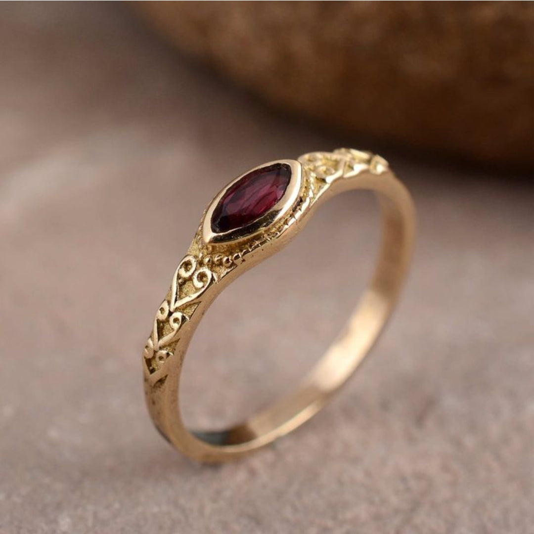 Golden vintage ring with red crystal