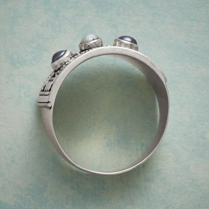 Geometric ring with carved pearl and three stones