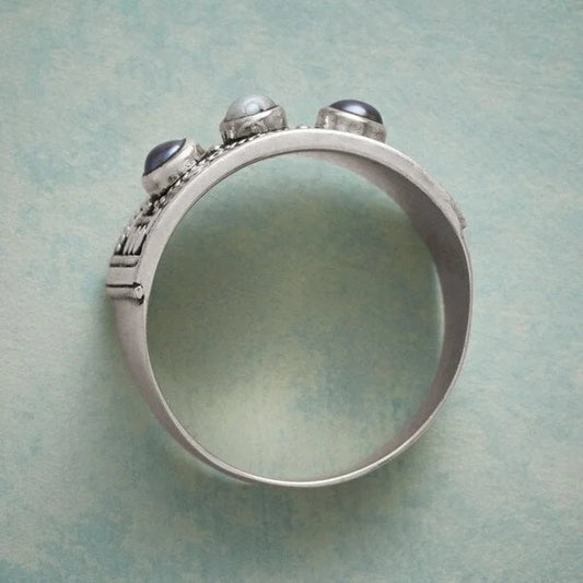 Geometric ring with carved pearl and three stones