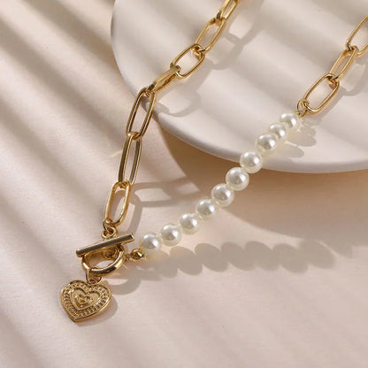 Crossed heart pendant with pearls in gold