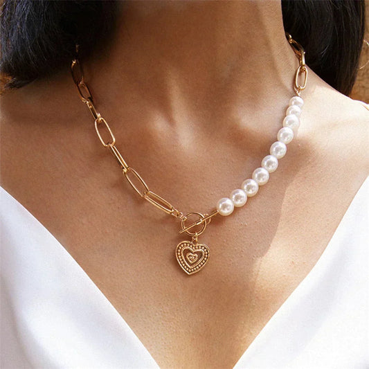 Crossed heart pendant with pearls in gold